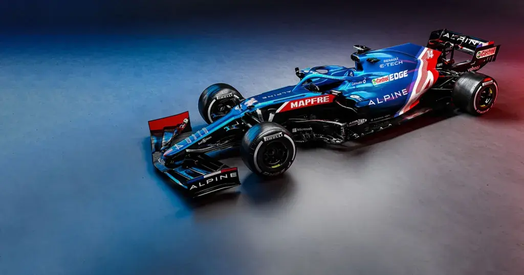 an Alpine F1 Race Car sitting in a showroom with red, white and blue ambient lighting