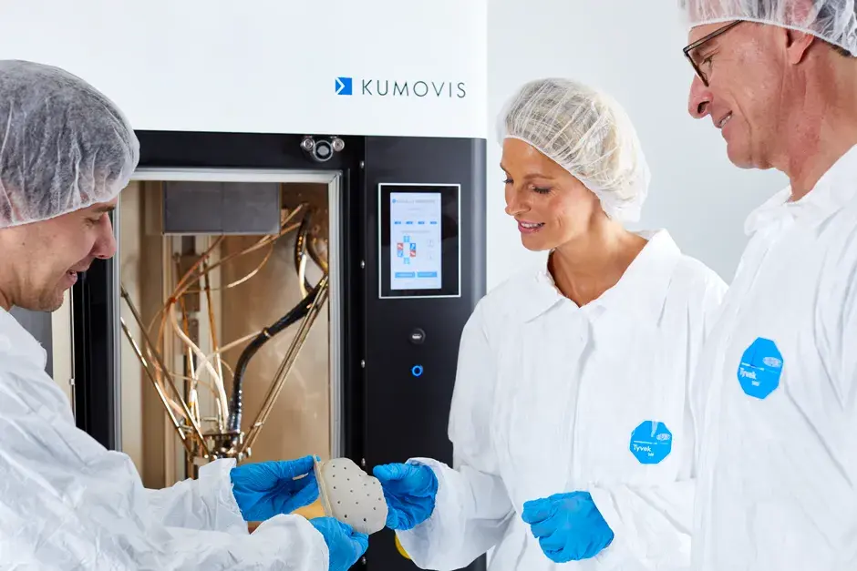 Medizinische Experten und Ärzte, die eine Schädelplatte aus dem EXT 220 MED 3D-Drucker herausholen