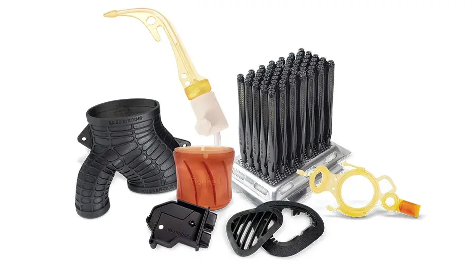 Mehrere 3D-gedruckte Teile auf blauem Hintergrund. Zu den Teilen gehören ein weißes Zahnrad, ein buntes medizinisches Modell und andere solide schwarze und graue Produktionsteile.